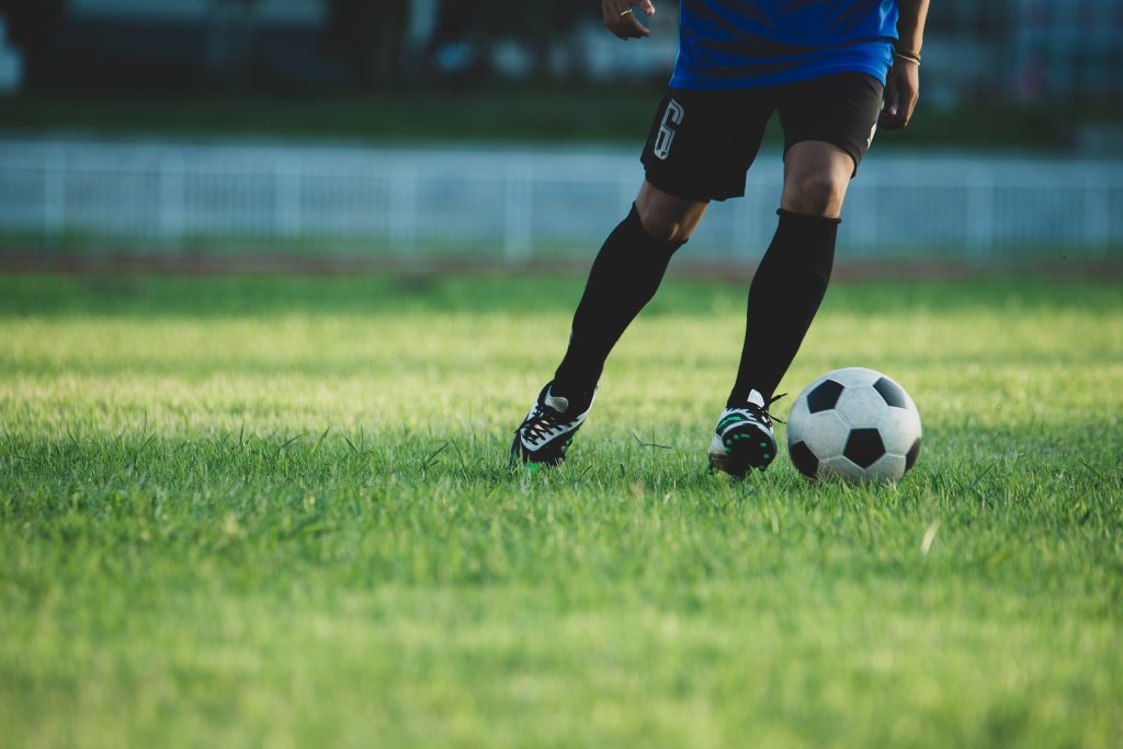 Soccer player action on the stadium @freepik